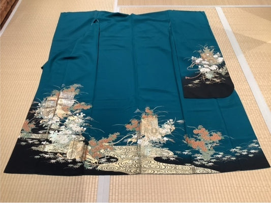 Furisode (long-sleeved kimono) in deep green and blue, featuring a court carriage, seasonal flowers, and flowing water.
