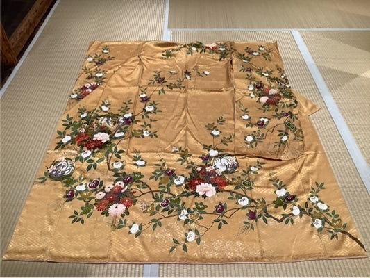 Furisode (long-sleeved kimono) in bright yellow-orange with mandarin orange, flower wreath, peony, chrysanthemum, wisteria, plum, and narcissus.